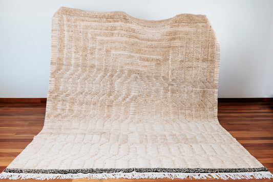 Beni Ourain tribal rug ivory color handmade in Morocco with mixed weaving technique flat-weaving and knot weaving featuring discrete stripe lines. The pattern adds depth and texture to the rug.