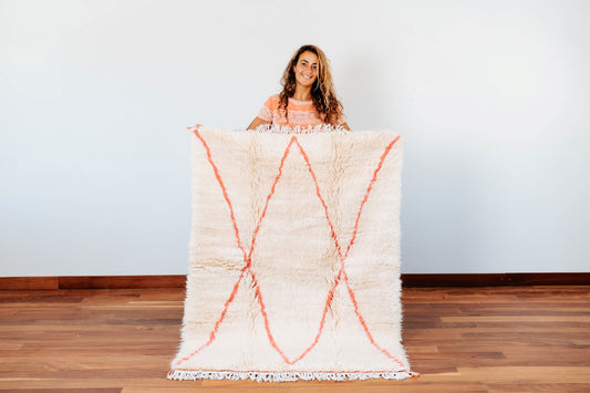 Beni Ourain tribal rug knot weaved handmade in Morocco and featuring symmetrical soft pink lozenge pattern. 