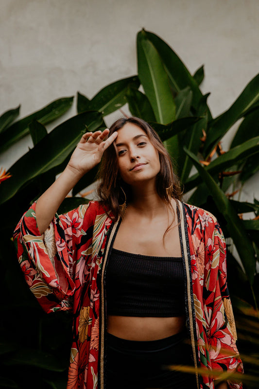 This cherry flowery kimono is gorgeous. We love the sassy side slits and the wide sleeves embellished with a golden thread. The neckline is enhanced by an elegant handwoven silk trim.