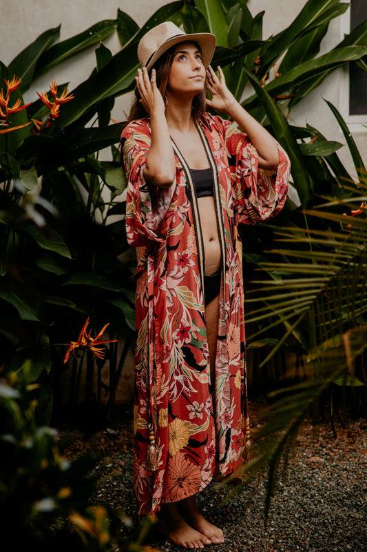 This cherry flowery kimono is gorgeous. We love the sassy side slits and the wide sleeves embellished with a golden thread. The neckline is enhanced by an elegant handwoven silk trim.