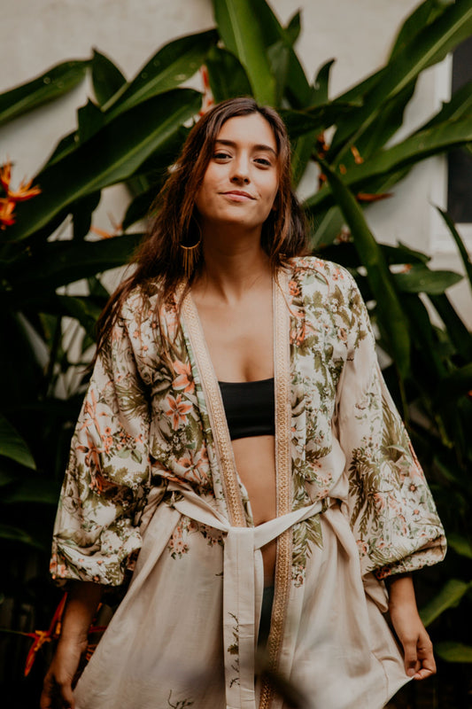This summer white kimono with floral print is gorgeous. We love the retro style of the puffy sleeves. The neckline is enhanced by an elegant handwoven golden silk trim
