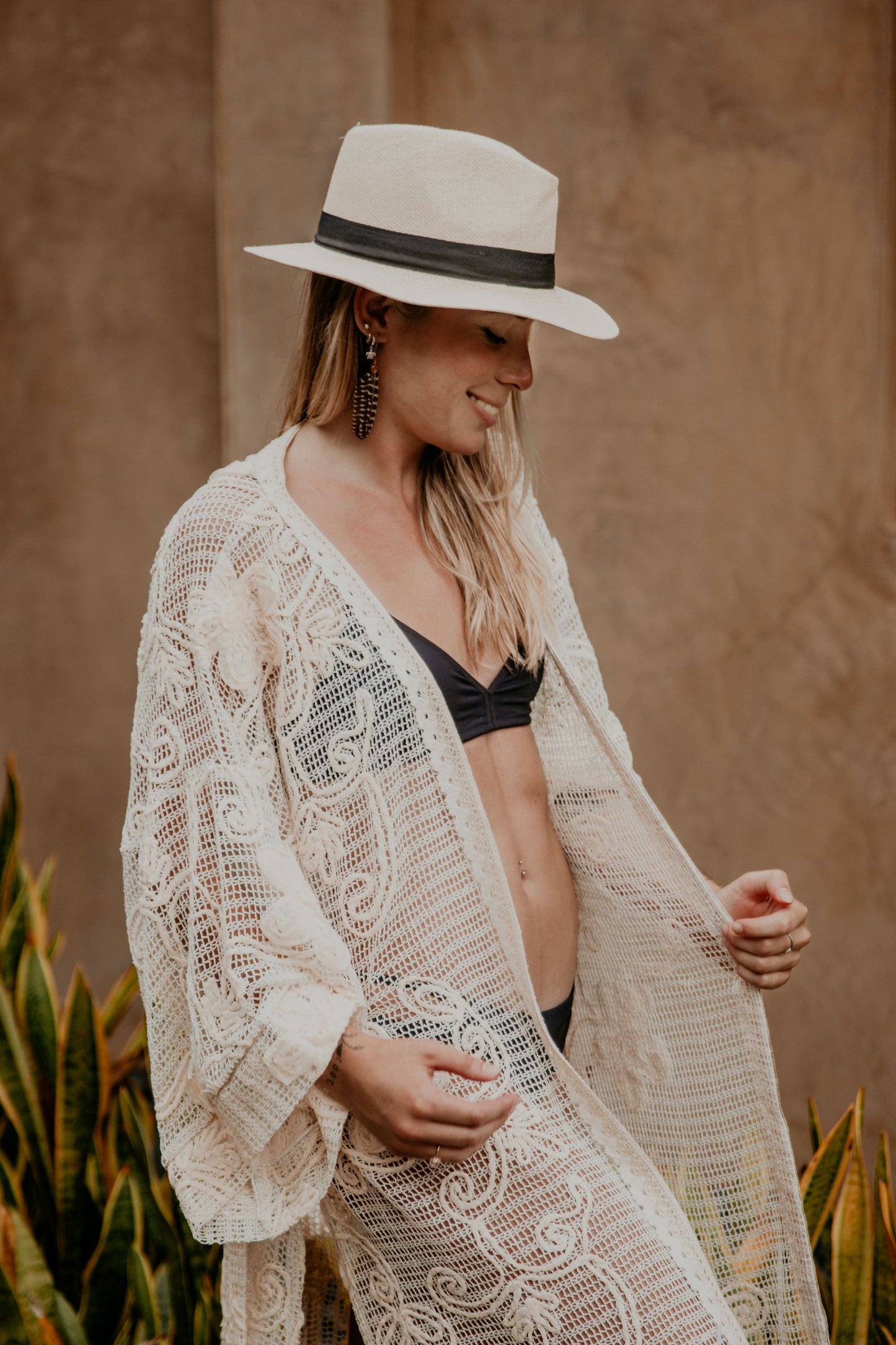 This macrame embroidered kimono is gorgeous. We love the sassy side slits, the wide sleeves and the delicate embroidered flowers that accentuate the Boho style of this kimono. The neckline is enhanced by an elegant handwoven trim.