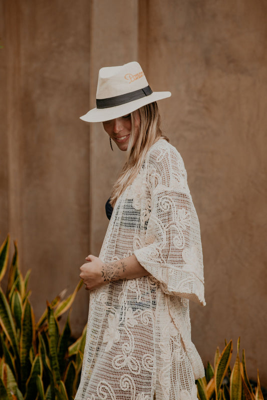 This macrame embroidered kimono is gorgeous. We love the sassy side slits, the wide sleeves and the delicate embroidered flowers that accentuate the Boho style of this kimono. The neckline is enhanced by an elegant handwoven trim.