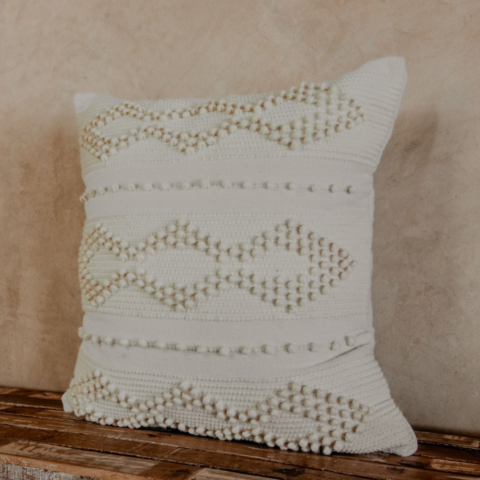 Prepare to fall in love with this compact accent pillow. A handwoven texture, a soft, neutral glow, and the coziness of premium cotton will make your bed, sofa or chair feel richer and more comfortable. 