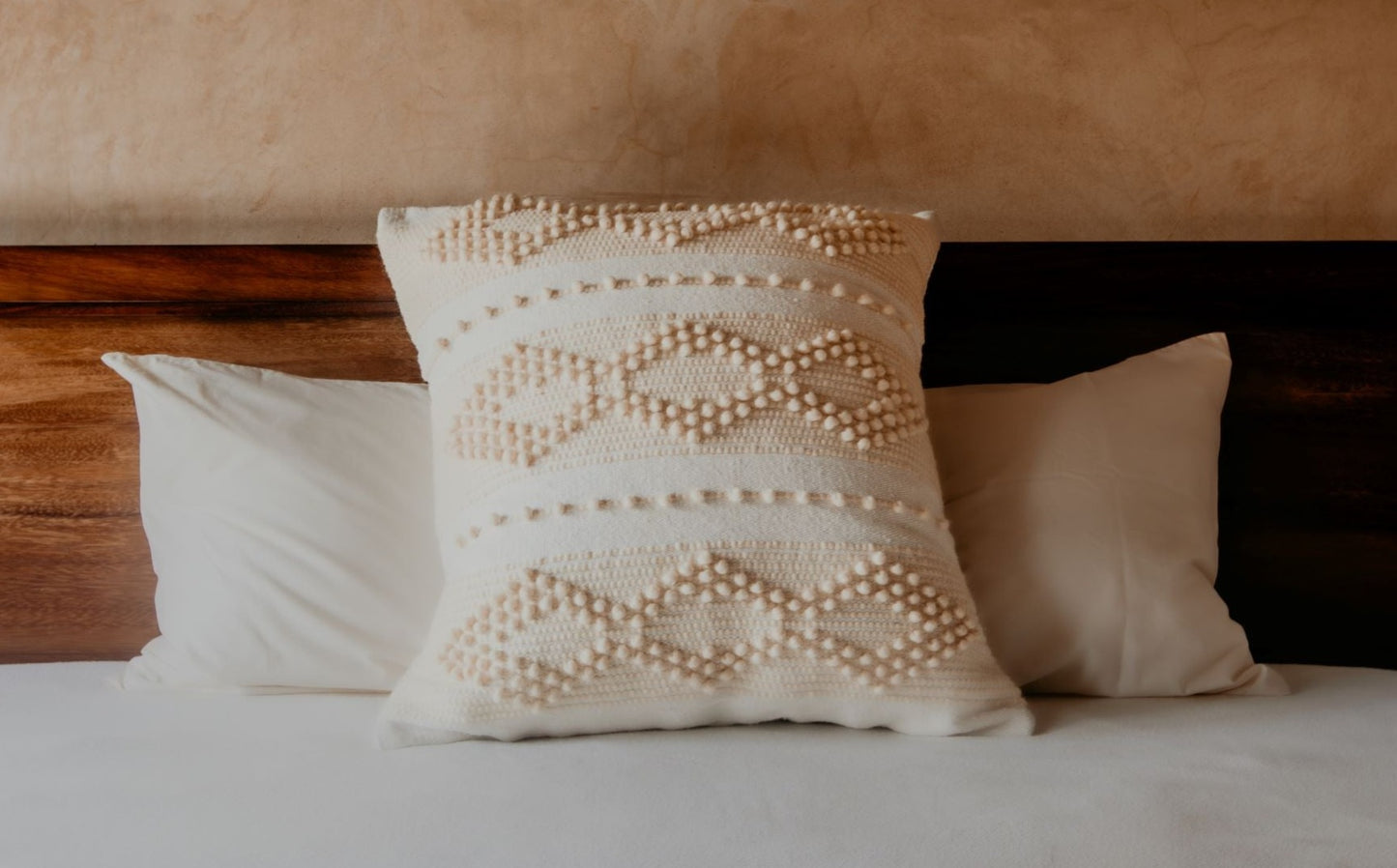 Prepare to fall in love with this compact accent pillow. A handwoven texture, a soft, neutral glow, and the coziness of premium cotton will make your bed, sofa or chair feel richer and more comfortable. 