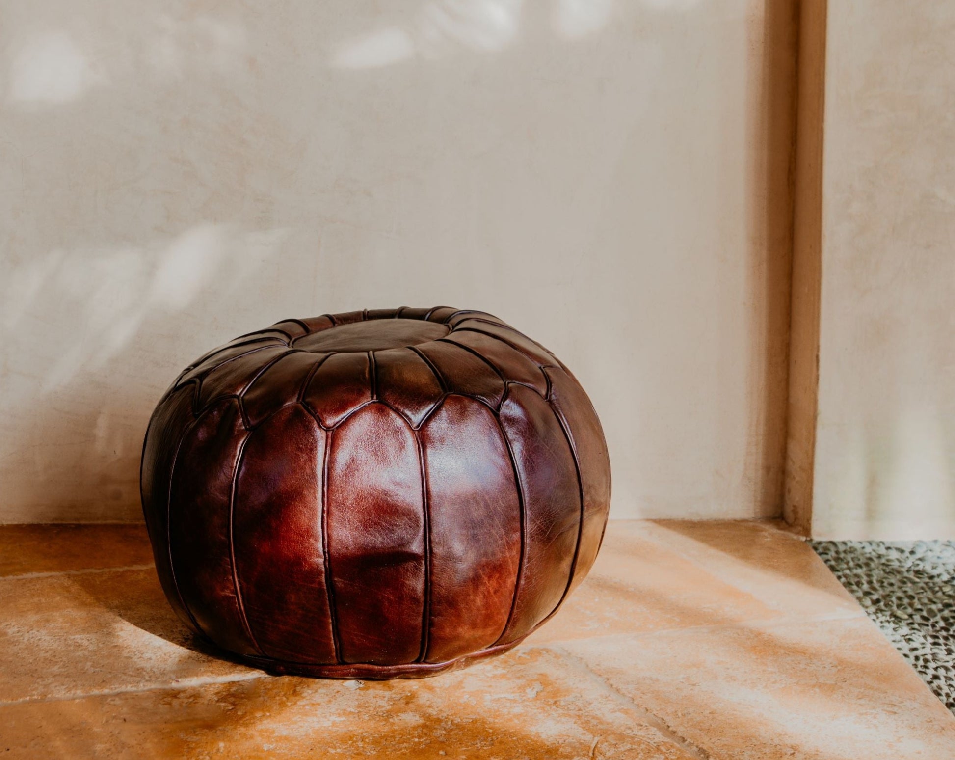 Hand stitched with premium leather, this Moroccan brown pouf is an essential piece in a contemporary or bohemian space.