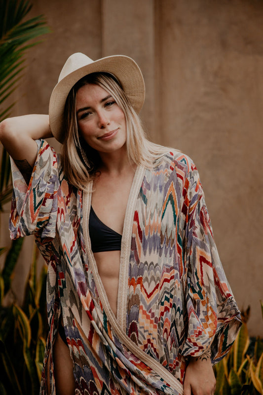 This Rainbow kimono is gorgeous. We love the sassy side slits and the wide sleeves embellished with a golden thread. The neckline is enhanced by an elegant handwoven silk trim.