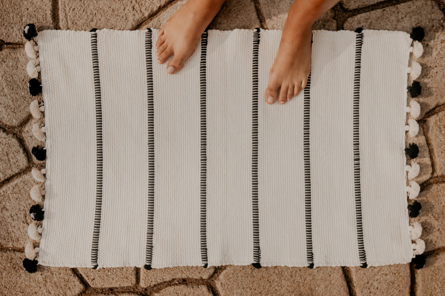 Hand-loomed using premium cotton, this highly absorbent and super soft bath rug will turn up the Boho vibes of your bathroom.