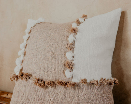 Pillows with blended textures in neutral tones like ivory and taupe are a nice way to make your space feel effortlessly chic. The tassels further add a playful personality to your sofa, bed, or armchair.