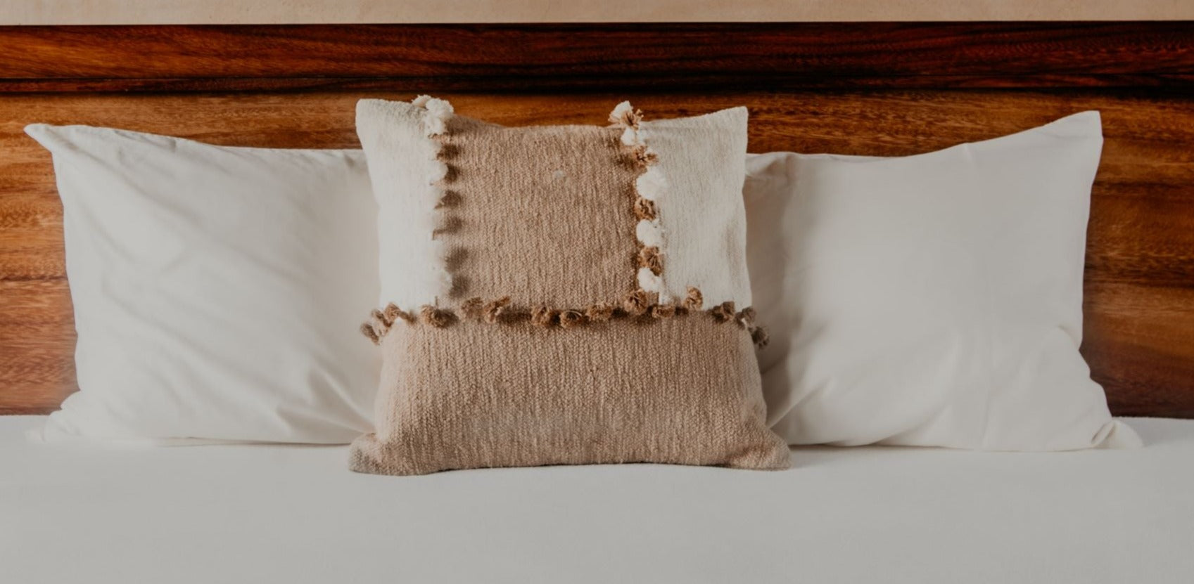 Pillows with blended textures in neutral tones like ivory and taupe are a nice way to make your space feel effortlessly chic. The tassels further add a playful personality to your sofa, bed, or armchair. 