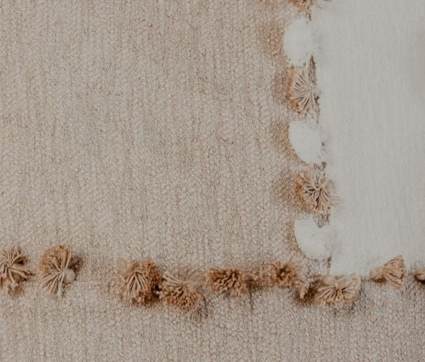 Pillows with blended textures in neutral tones like ivory and taupe are a nice way to make your space feel effortlessly chic. The tassels further add a playful personality to your sofa, bed, or armchair. 